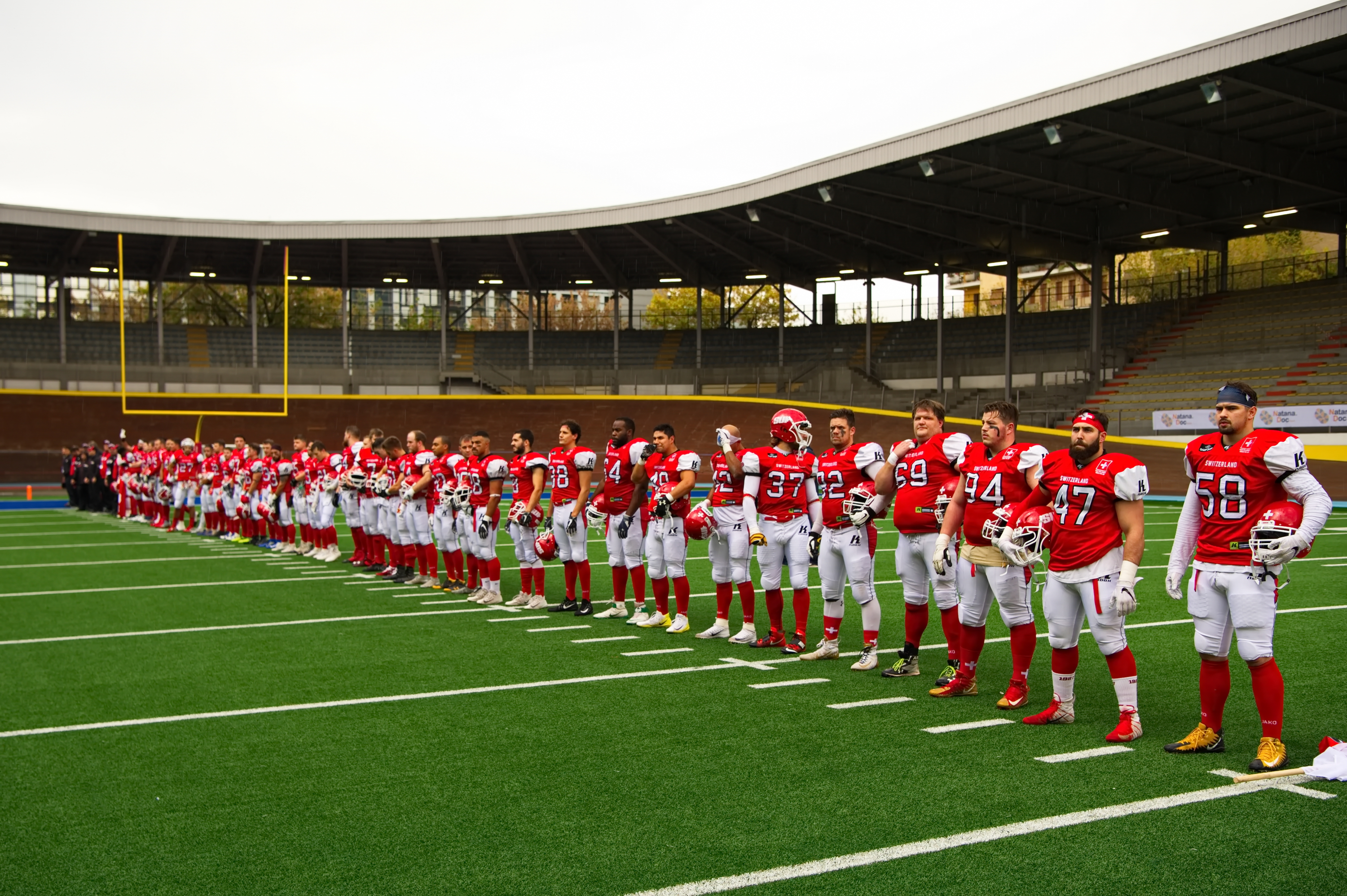 The national team standing ready before the game for the national anthem.